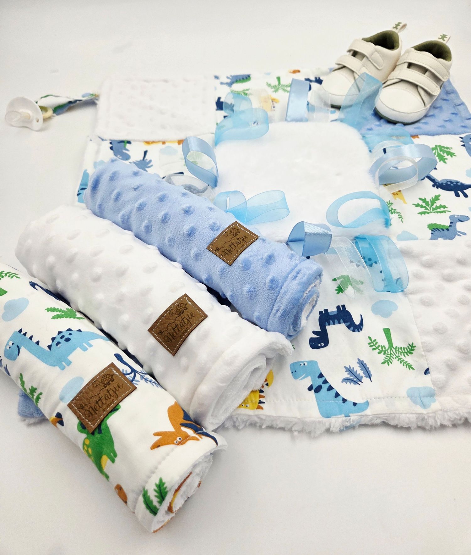Soft minky baby blankets with dinosaur prints in blue and white colors.