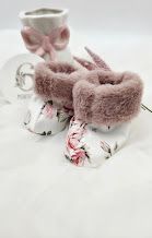 Adorable baby booties with floral print fabric and soft pink faux fur trim, perfect for newborns.