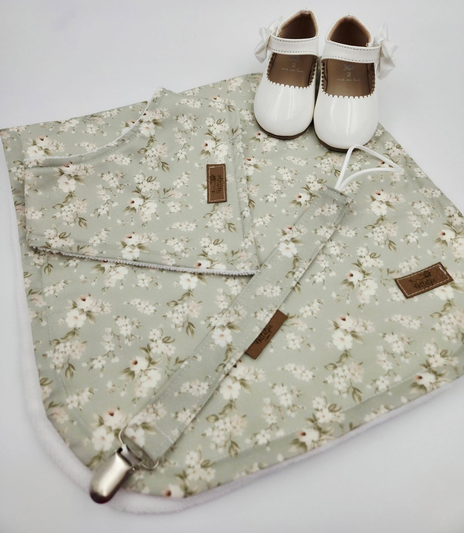 Sage green floral print baby blanket set with coordinating shoes and accessories.
