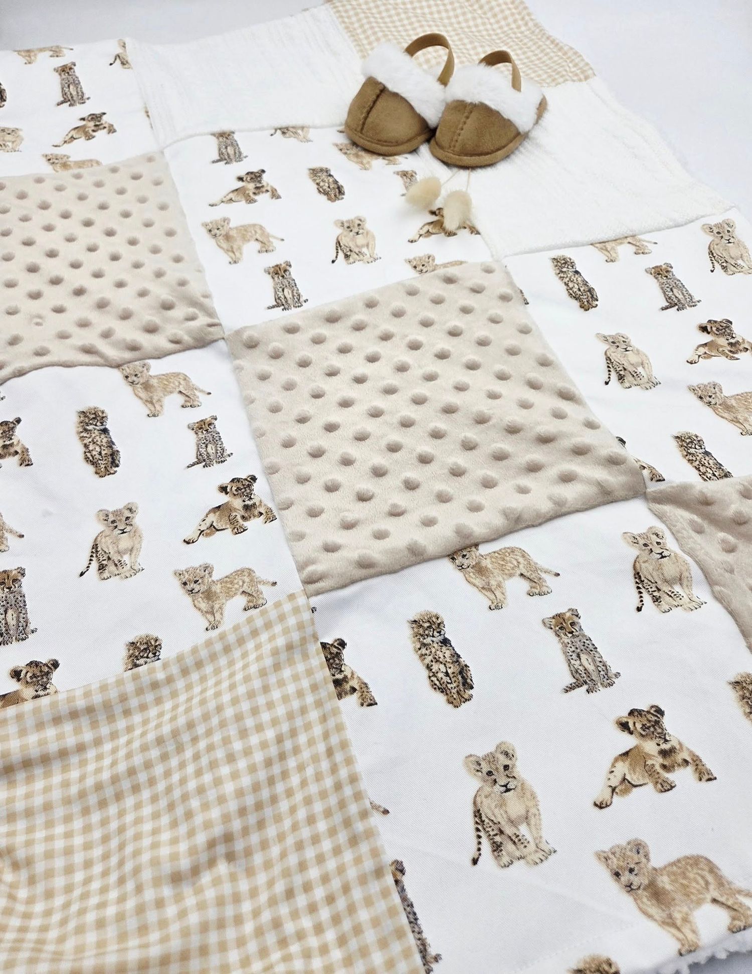 Baby blanket with puppy print pattern on white background paired with beige minky fabric.