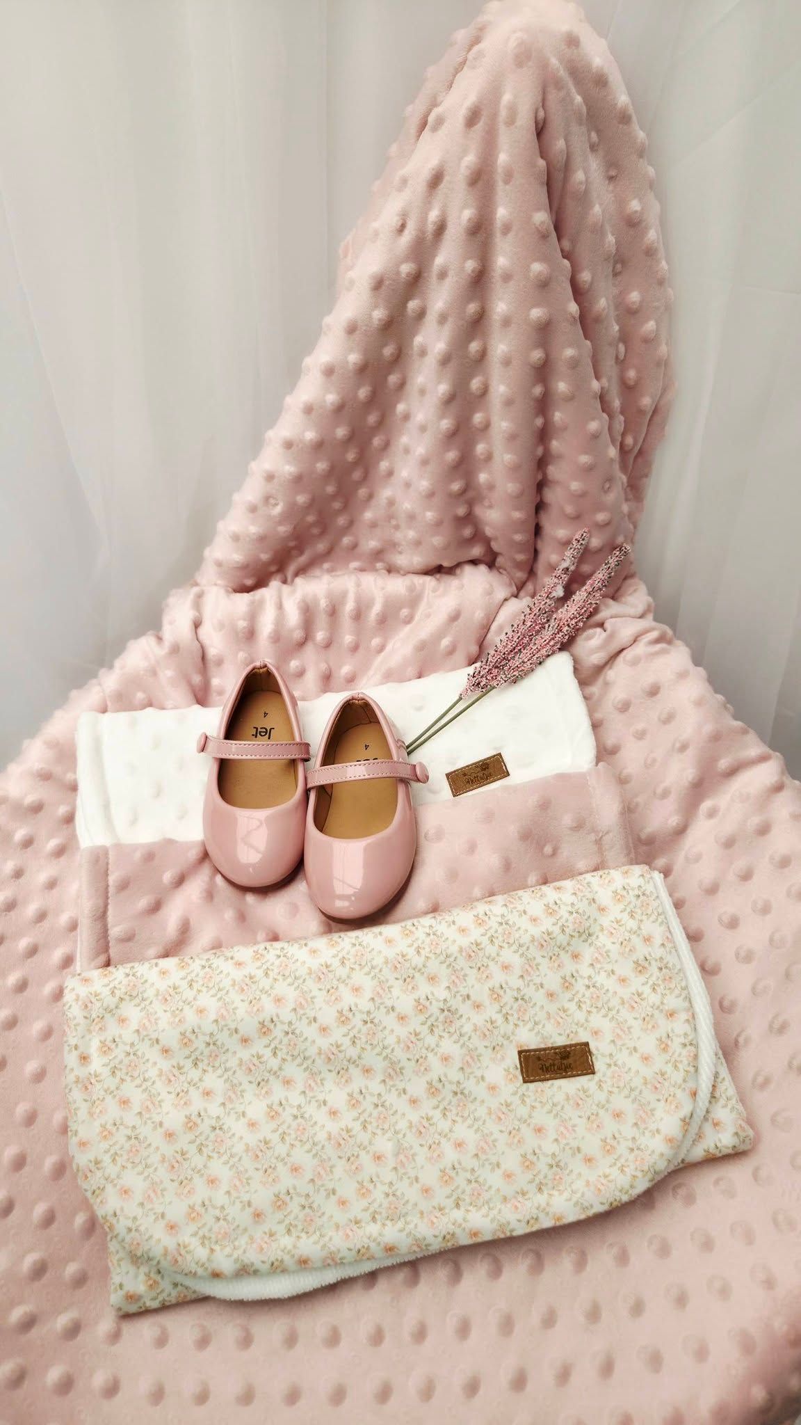 Pink baby girl gift set with Mary Jane shoes, floral blanket, and soft minky dot blanket arranged elegantly.