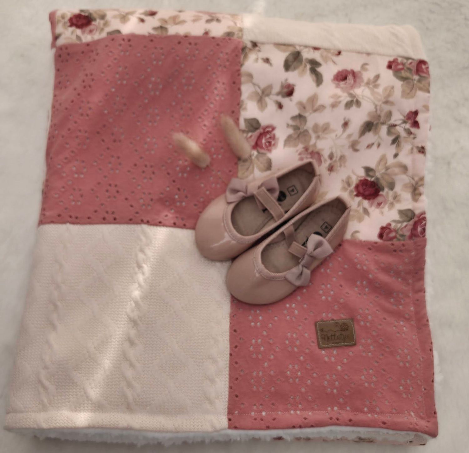 Pink floral patchwork baby blanket with matching blush bow Mary Jane shoes, perfect for newborn gift set.
