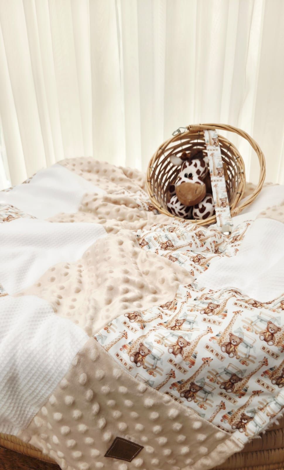 A cozy nest of spotted brown feathers and white bedding material shows intricate natural textures.