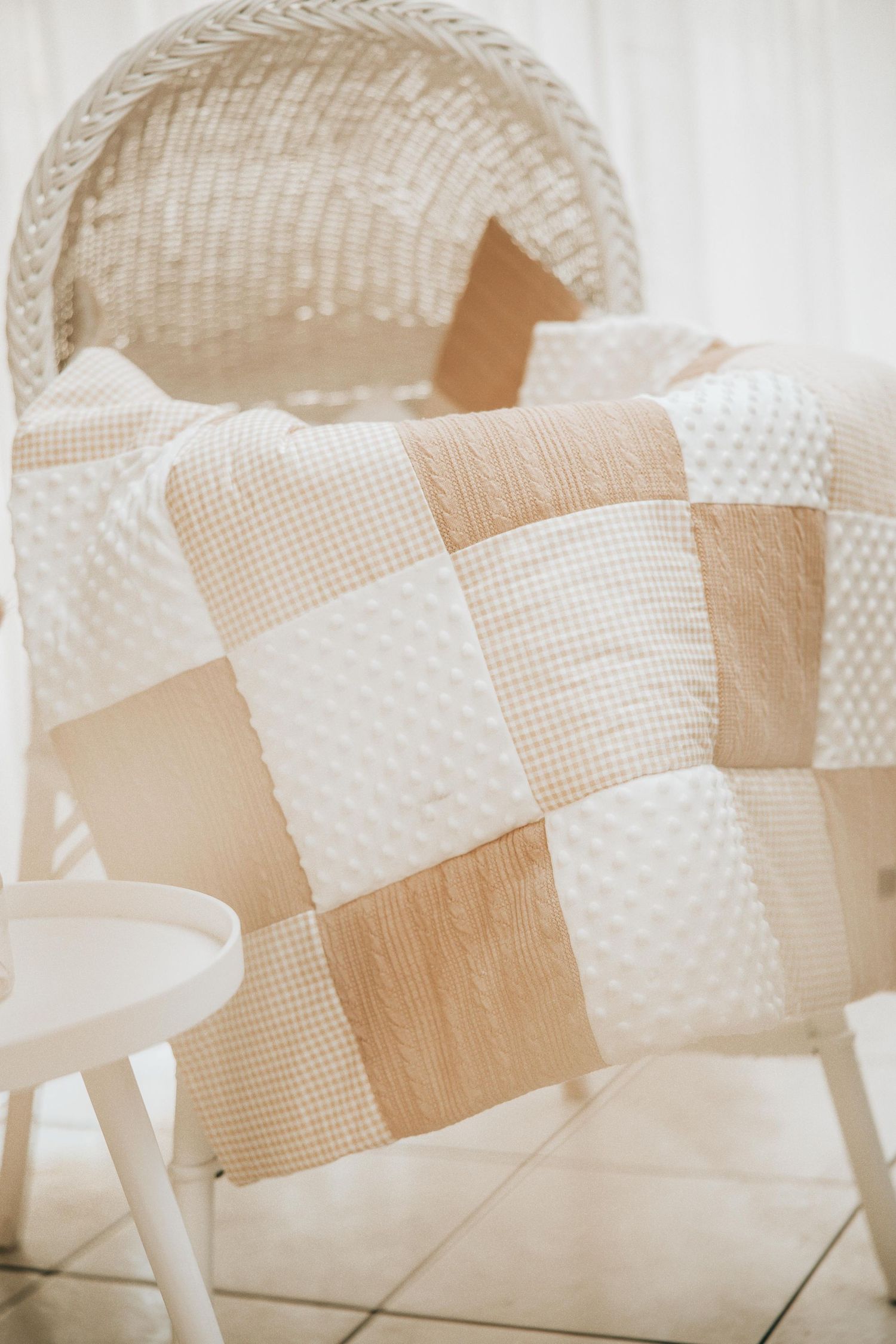 White textured chairs with a woven pattern arranged in a row against a light-colored background.