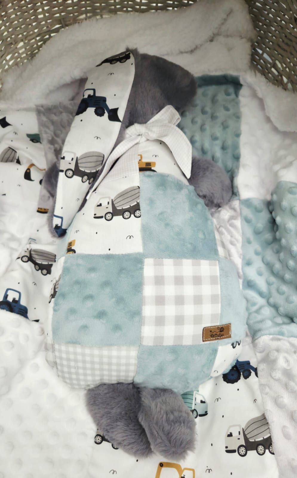 Handmade baby nest with blue gingham, minky dot fabric, and construction truck print, perfect for newborns.