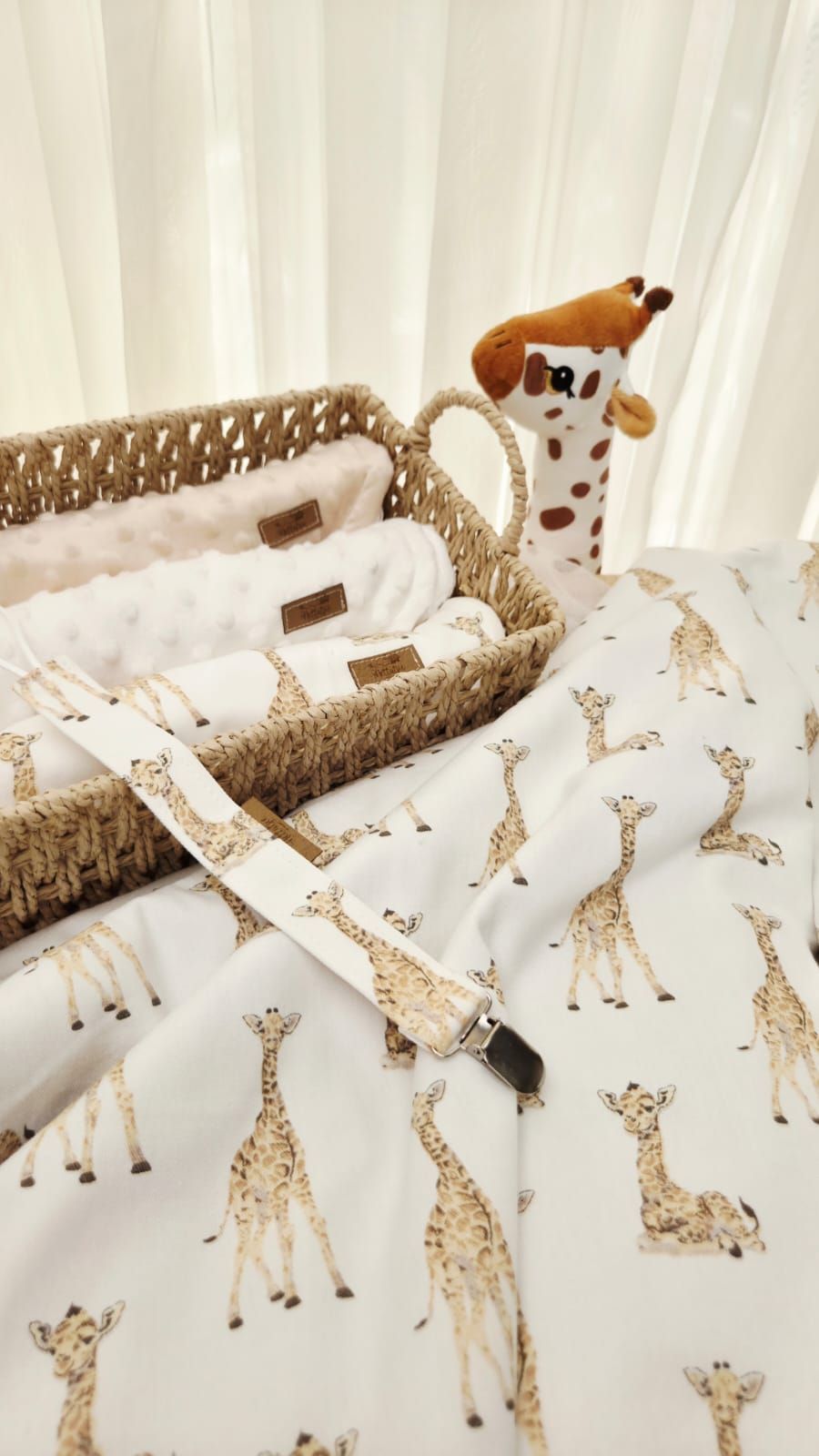 White and gold giraffe print crib bedding with braided trim creates a sweet safari-themed nursery design.