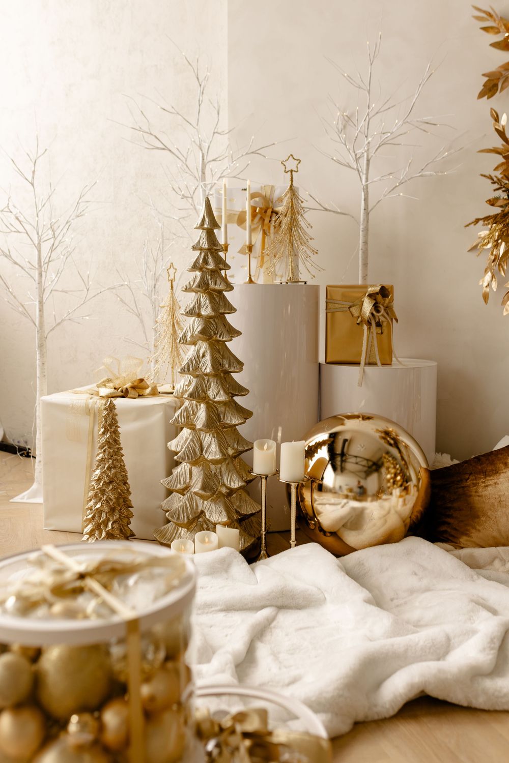 Festive winter wonderland decoration with white birch trees, evergreens, and faux snow on display.