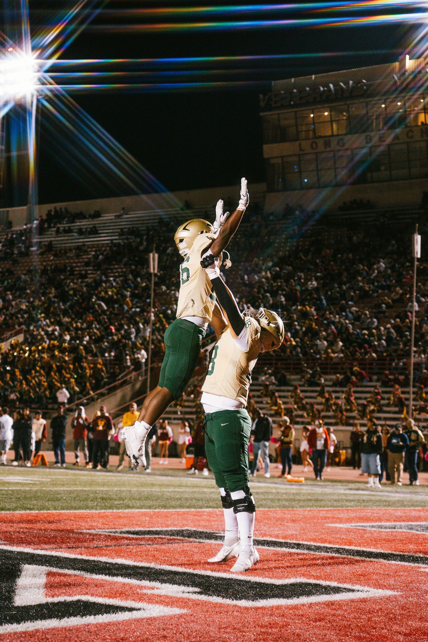 Football player in navy Falcons uniform number 2 poses during a nighttime game.