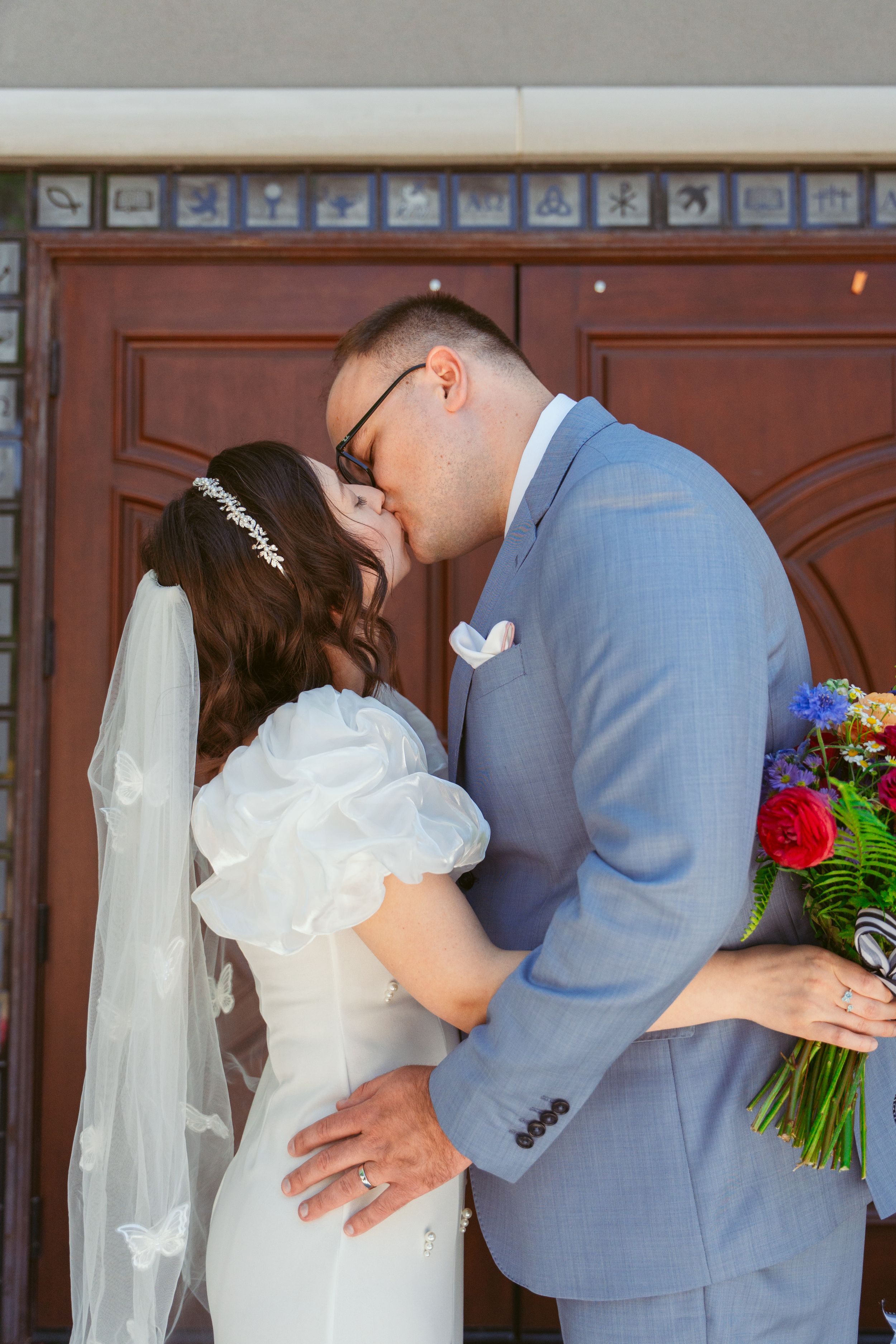 A romantic first kiss as newlyweds shown in a multi-panel sequence against a light background at their wedding ceremony.