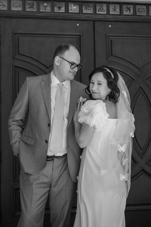 Black and white photo collage showing a couple in wedding attire exchanging gentle moments from different angles.