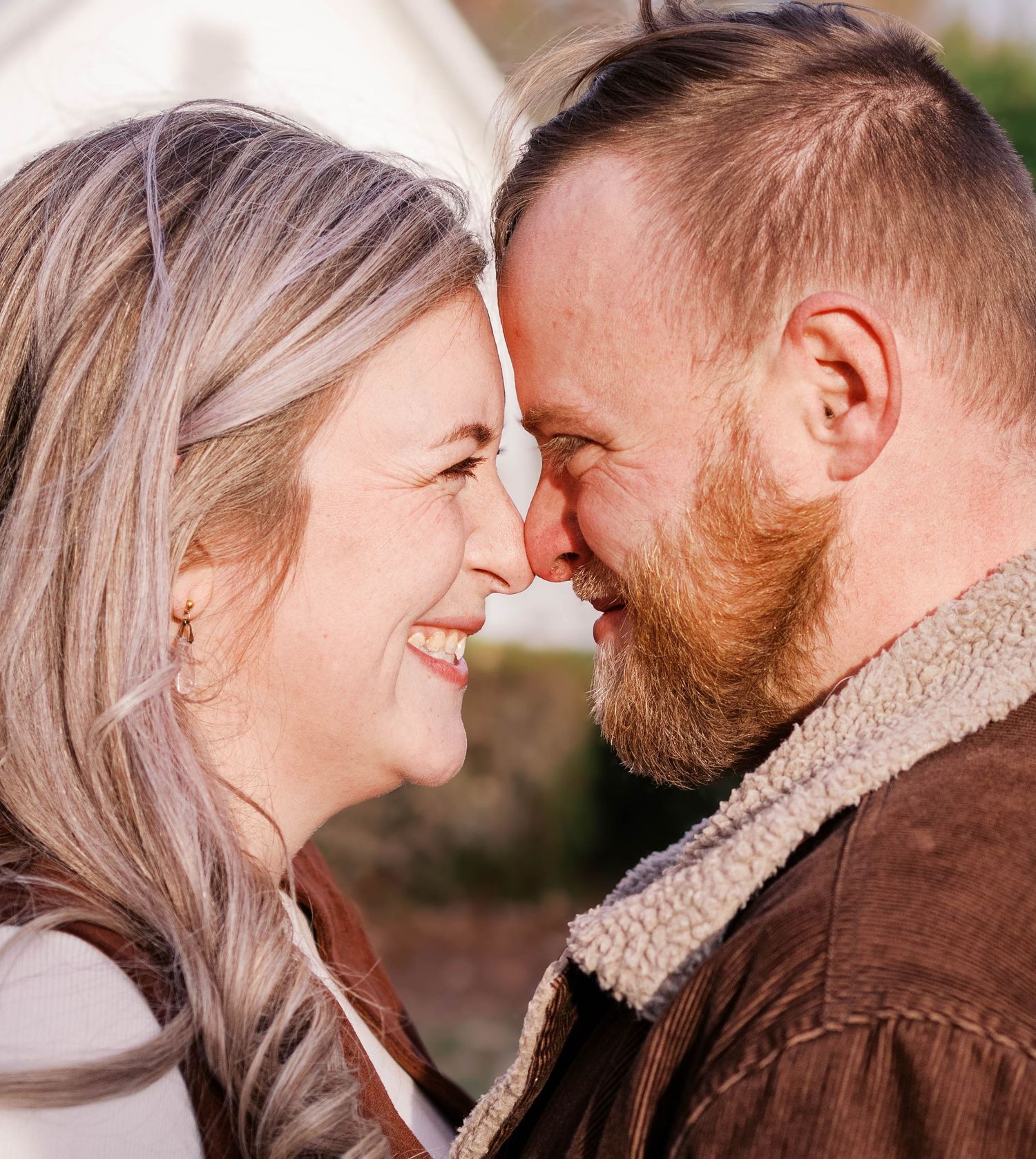 A tender romantic moment shared between a couple in soft lighting.