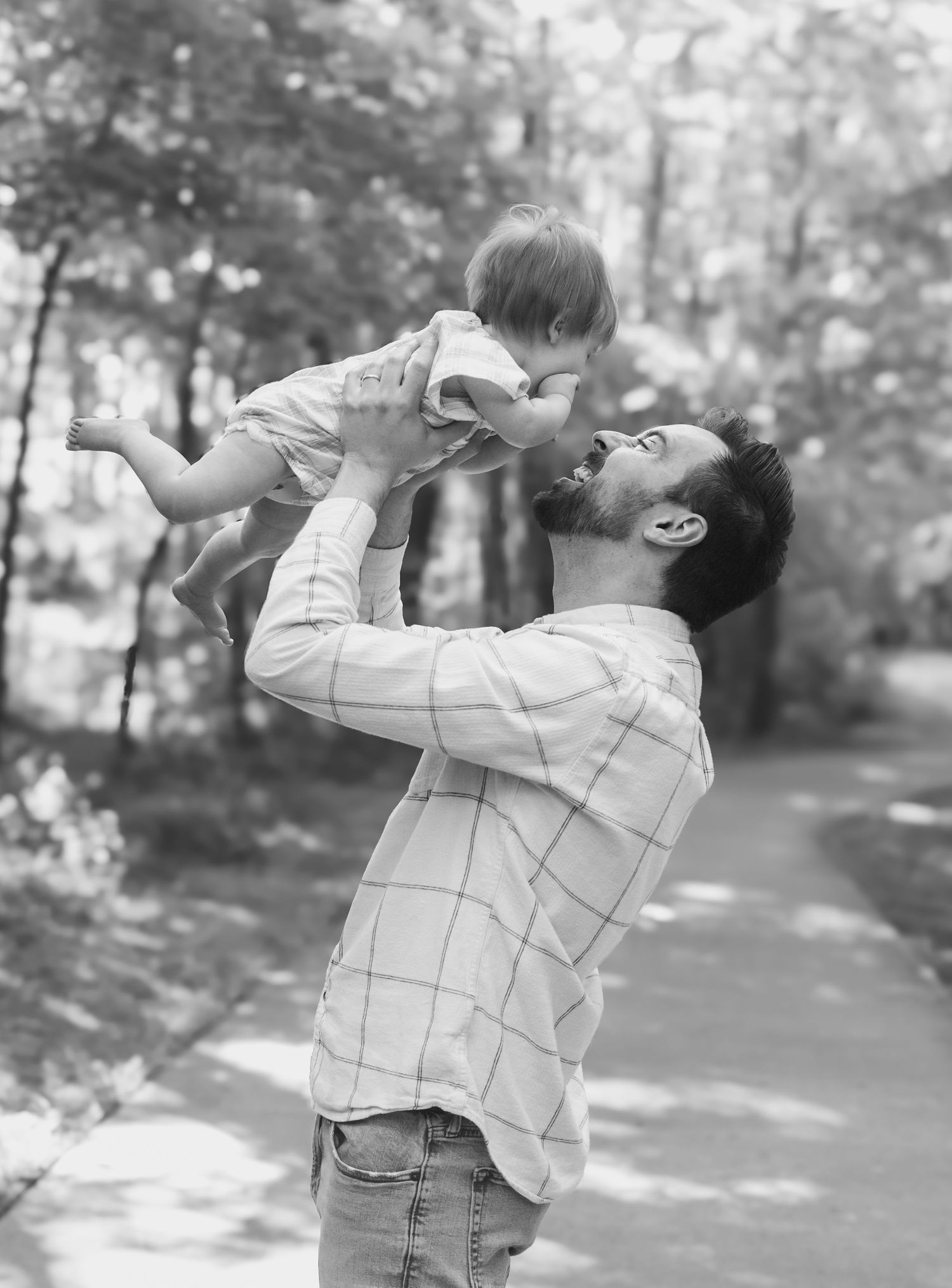 A playful dance sequence in black and white photography outdoors.