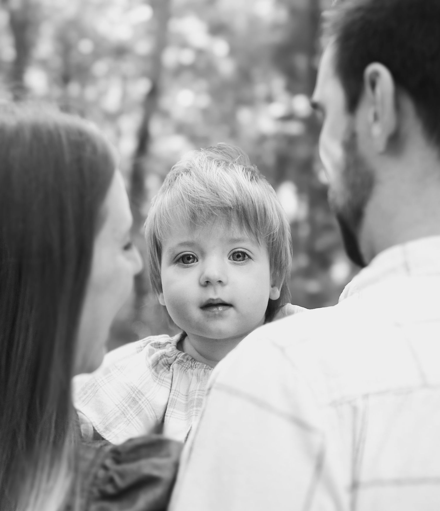 A series of sweet interactions between family members in black and white.