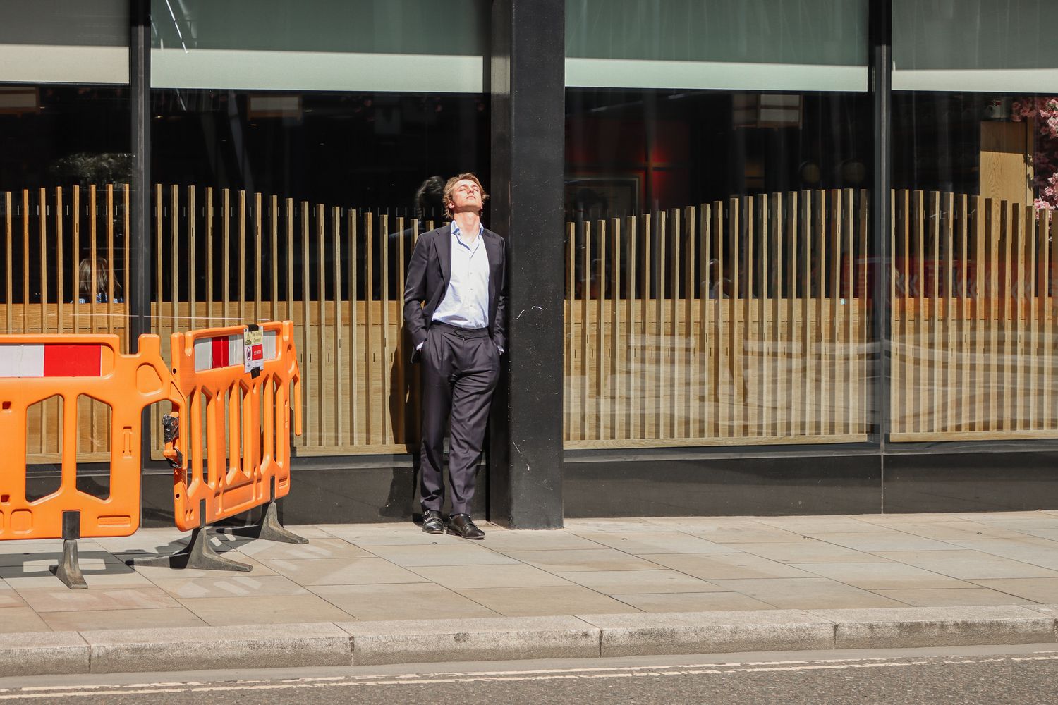 catching the sun on a lunchbreak in city of london. candid street photography by emma drohan
