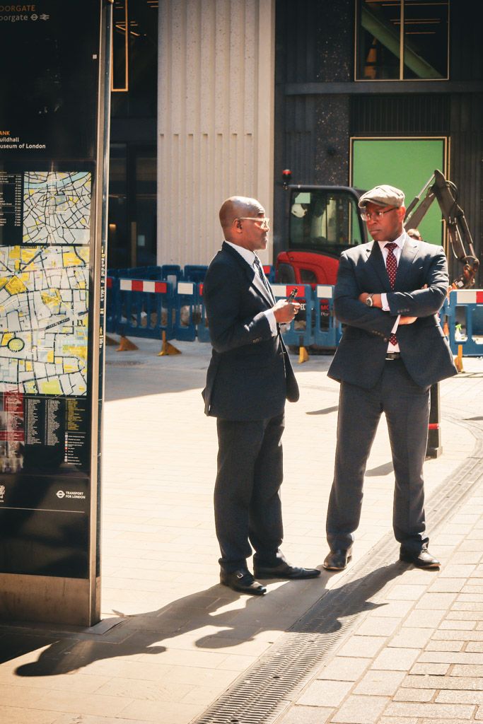 businessmen in suits having a conversation in city of london.  street photography by emma drohan