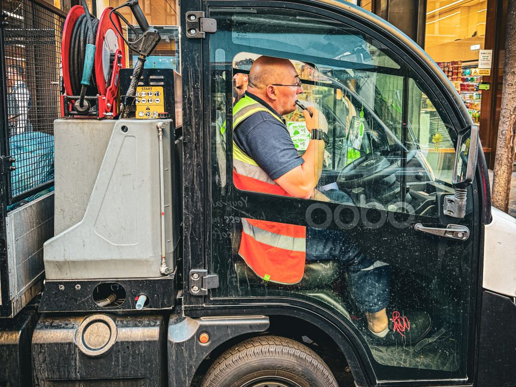 Road sweeper cart at work in central London.  street photography by emma drohan