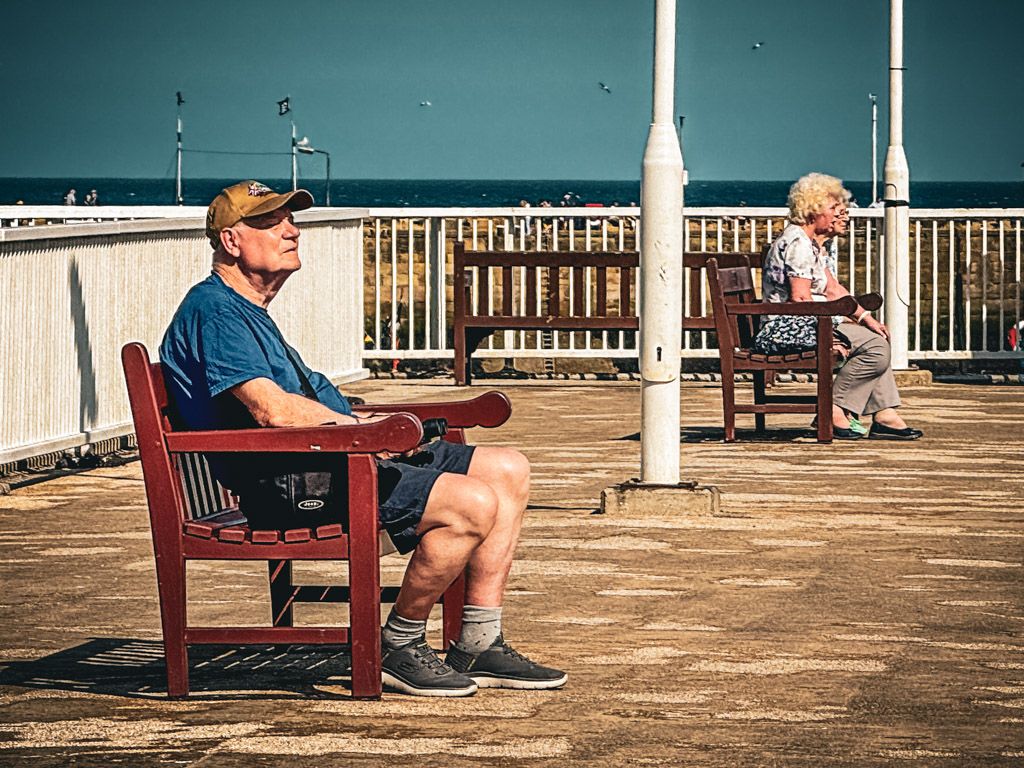 sat on the bench on the promenade in bridlington.  yorkshire photography by emma drohan