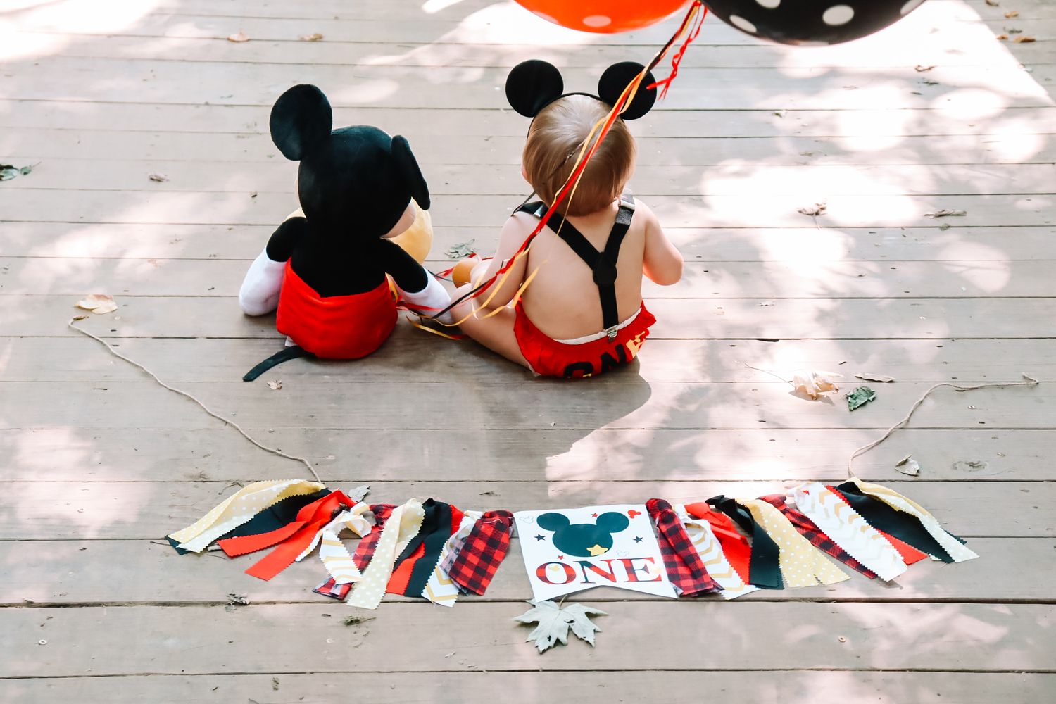 Process shots showing vinyl wallpaper being laid out and installed on a wooden floor with colorful geometric patterns.