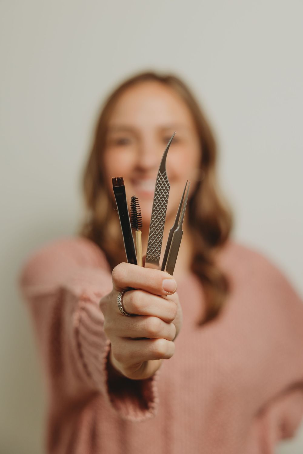 Five sequential images show feminine hands against a neutral background holding and displaying decorative washi tape rolls.
