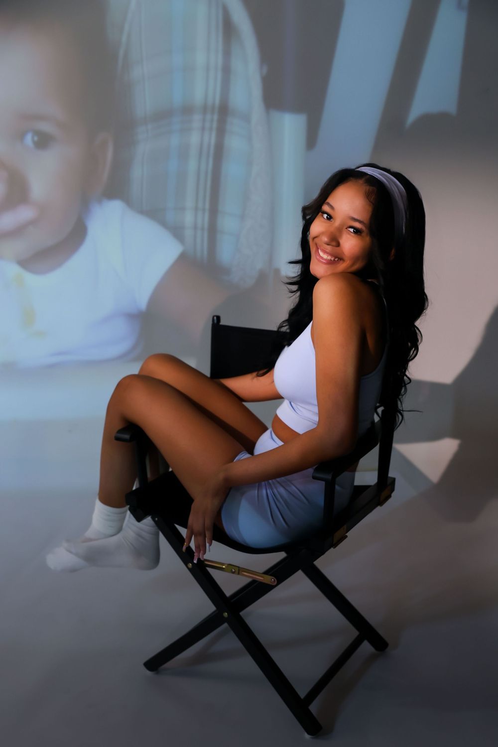 Artistic portrait series in casual wear with projected background.