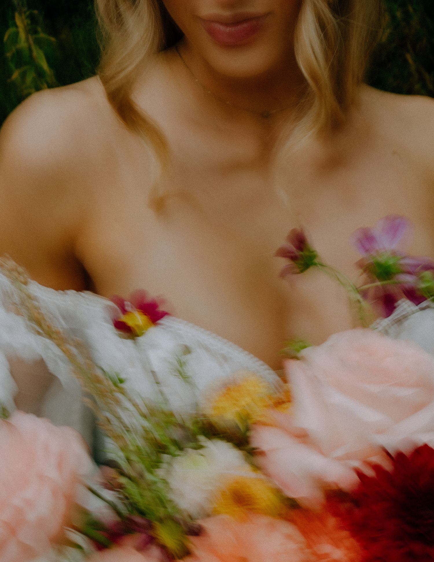 Soft-focus romantic image of flowers including roses and pink blooms against a blurred background.