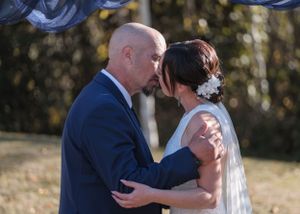 bride and groom kiss at alter in autumn wedding North Canterbury