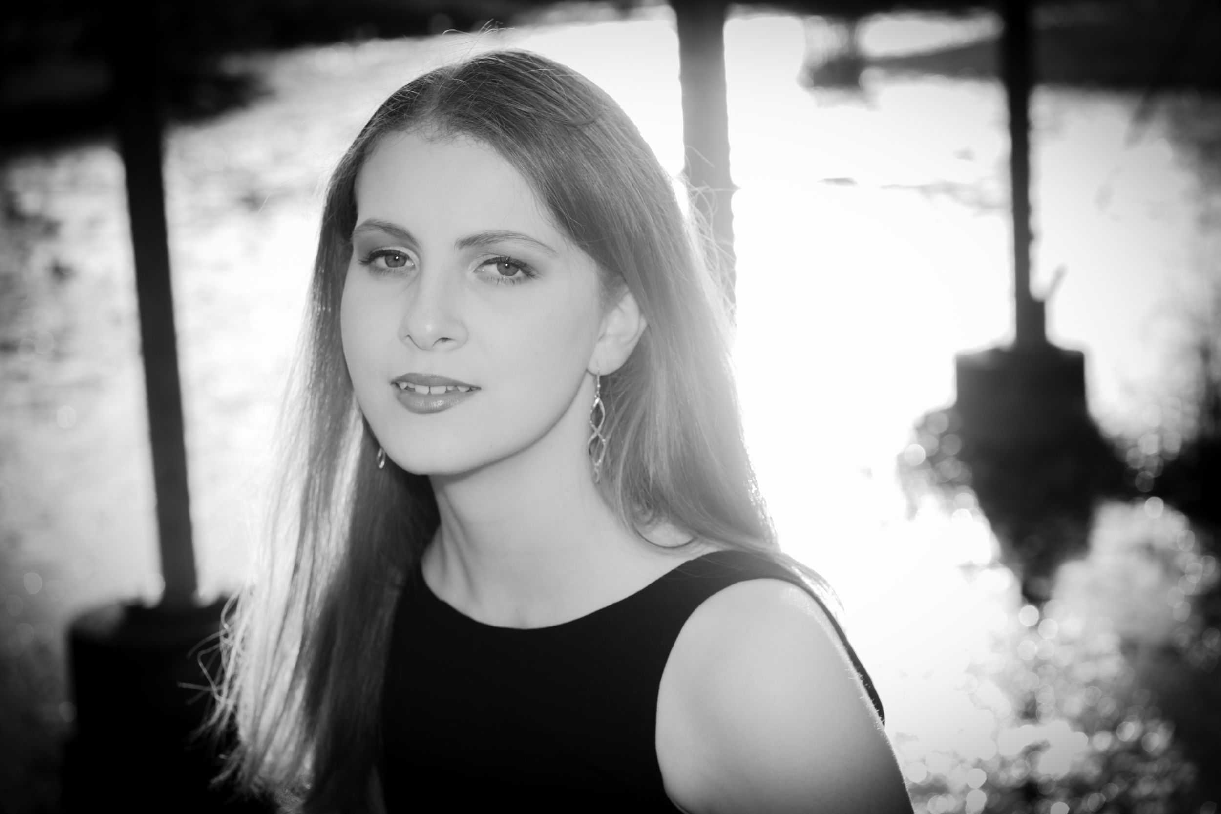 Black and white portrait with dramatic backlighting.