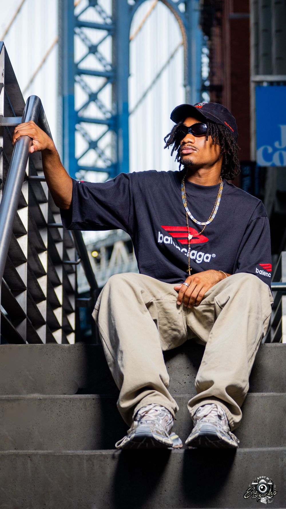 Casual street style photo featuring navy shirt and khaki pants near Manhattan Bridge.