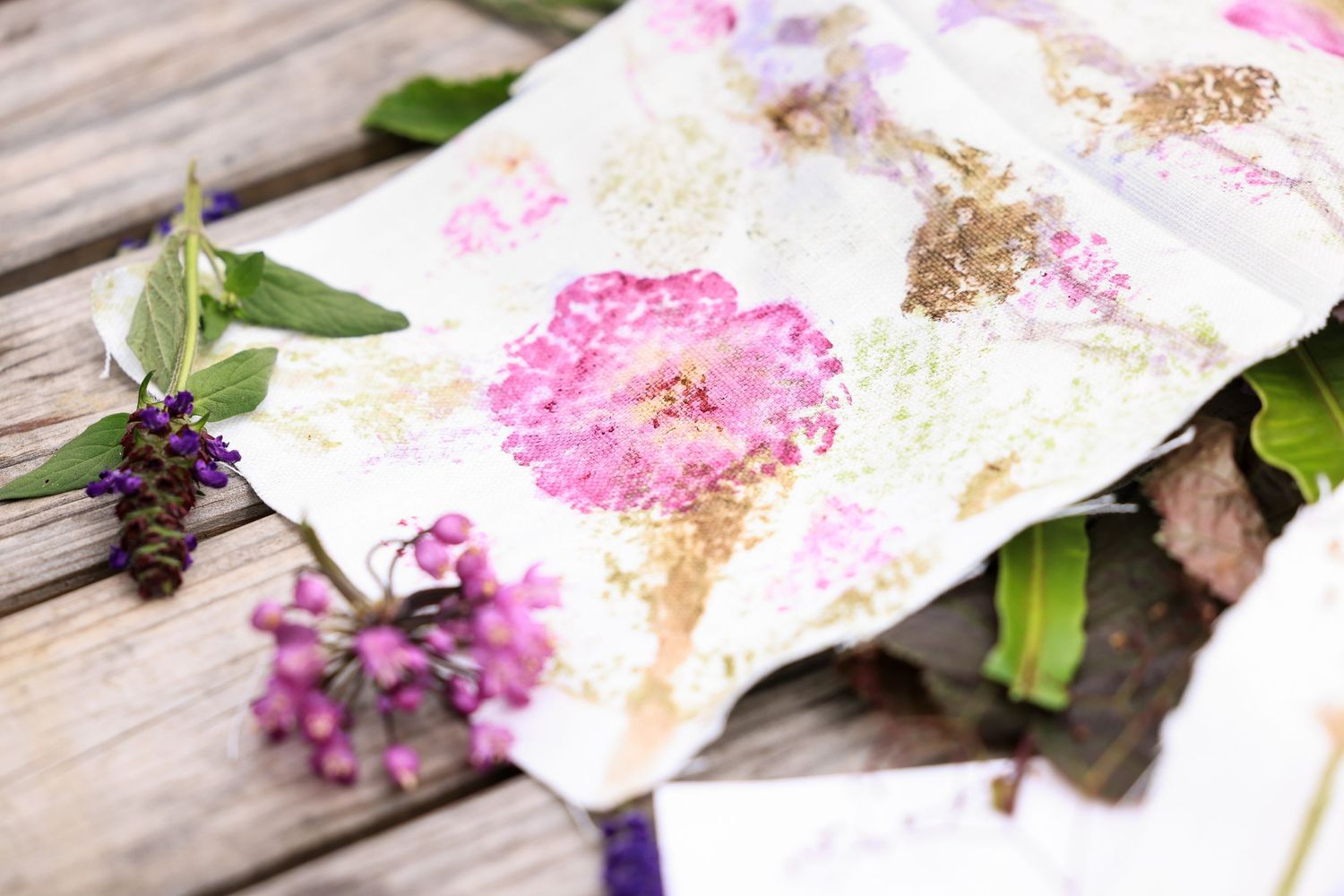 A wooden table with flowers and fabric