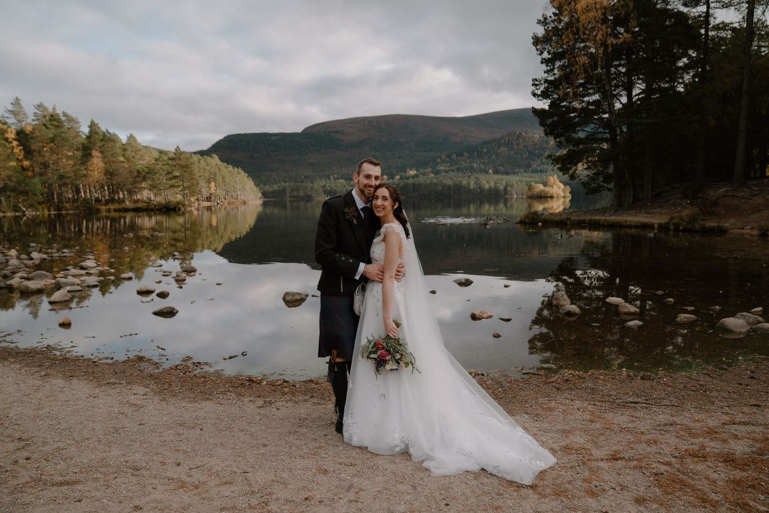 Scottish wedding couple exits church while guests celebrate their union.
