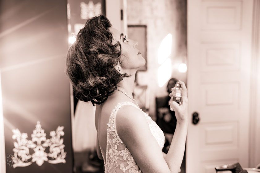 Elegant vintage-style wedding hair preparation photo in sepia tones.
