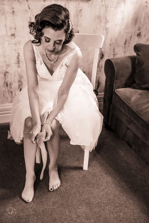 Vintage-inspired scene of wedding preparation in a sitting room.
