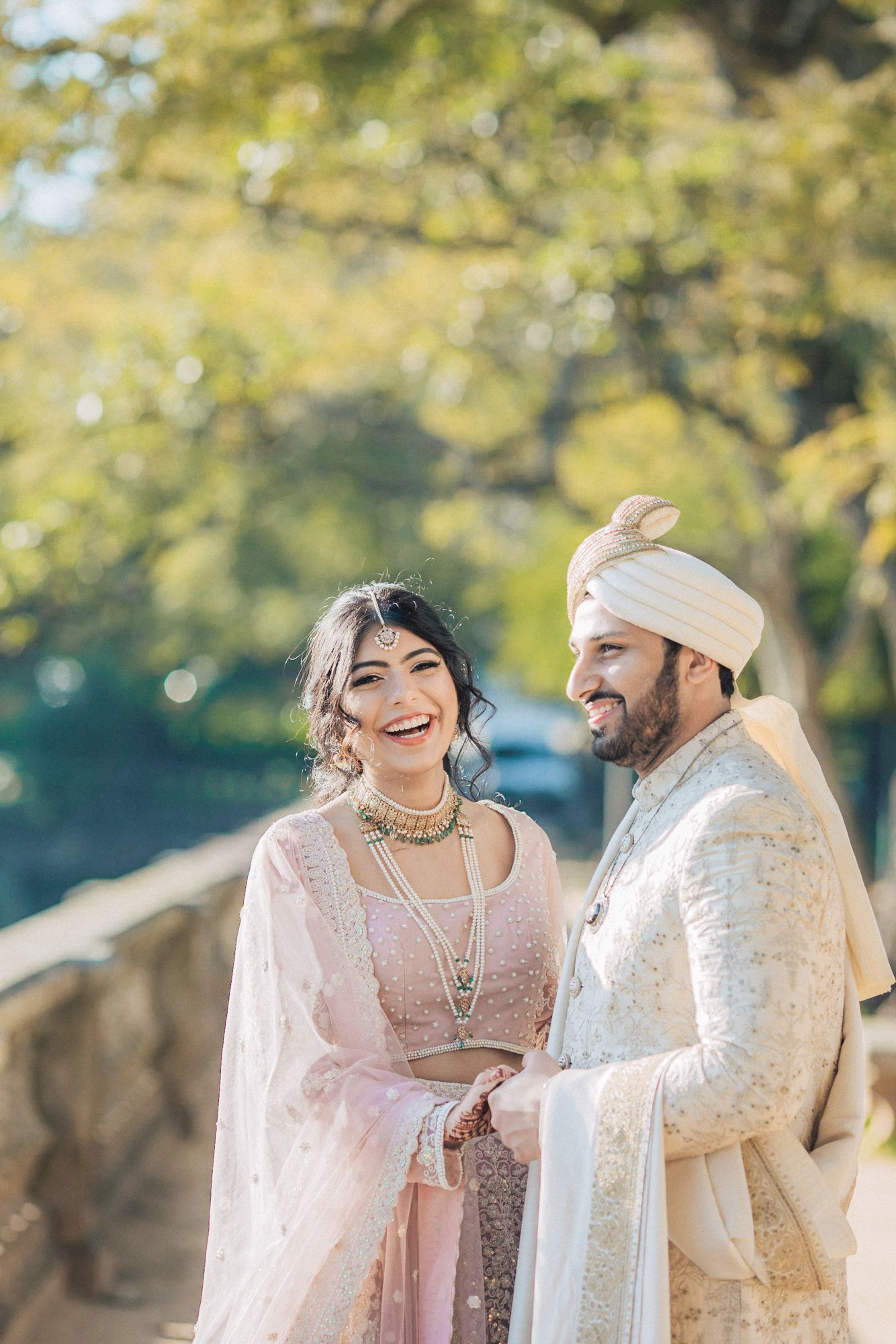 A joyful Indian couple at vandelli botanical garden. A moment captured by a Portugal destination wedding photographer