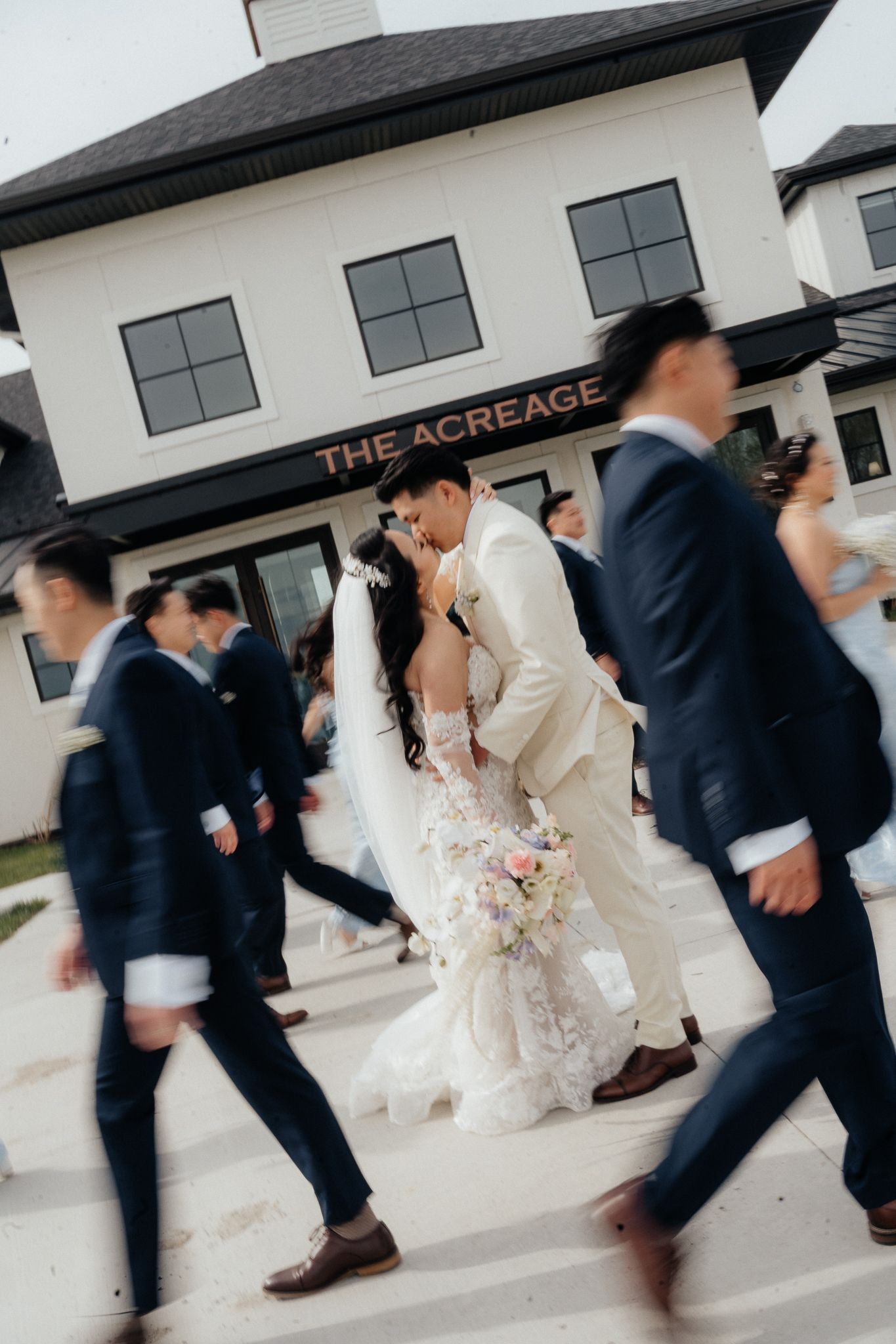 Wedding party walking outside The Acreage venue in formal attire.