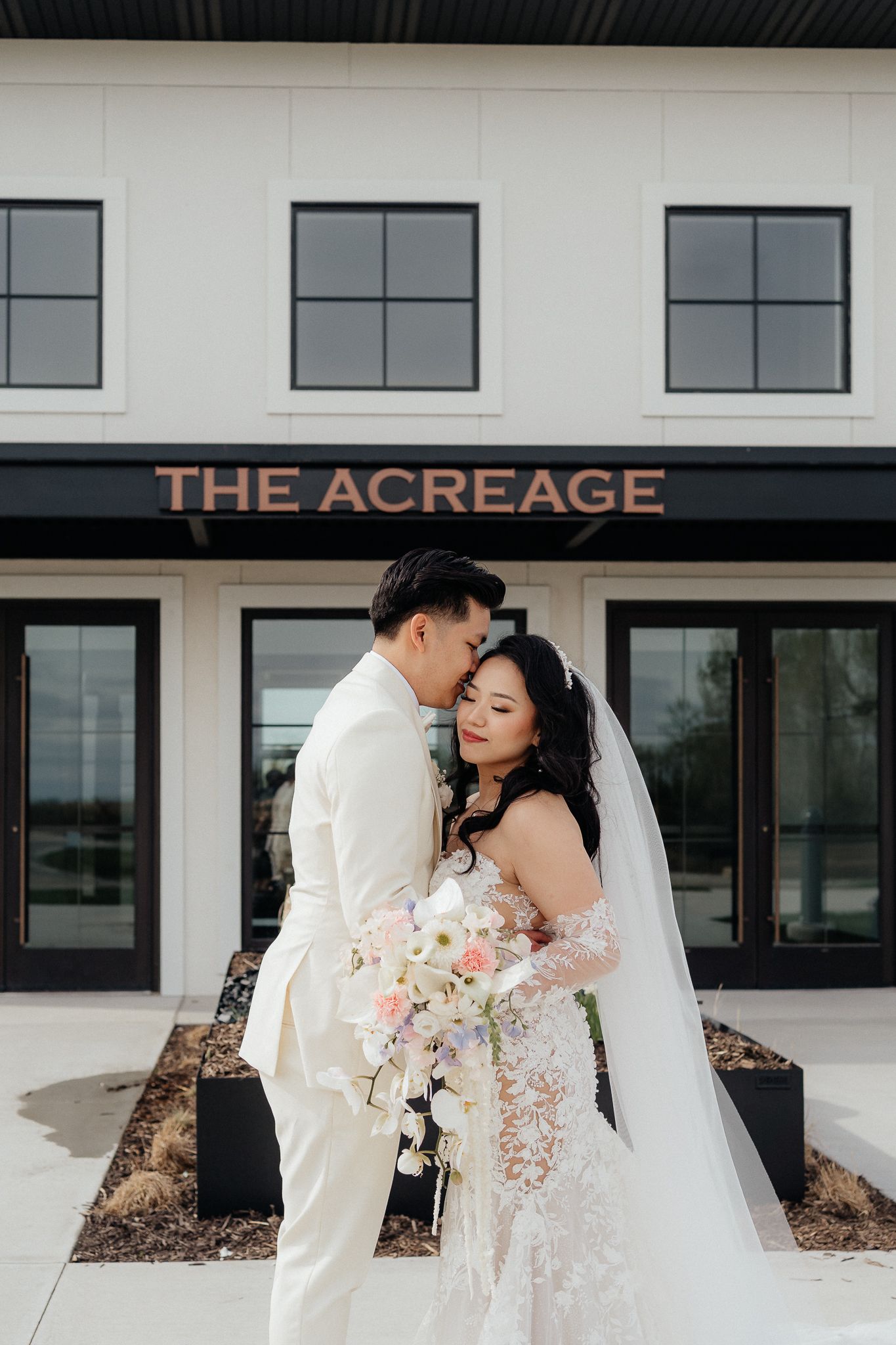 Romantic wedding portrait in front of The Acreage venue.