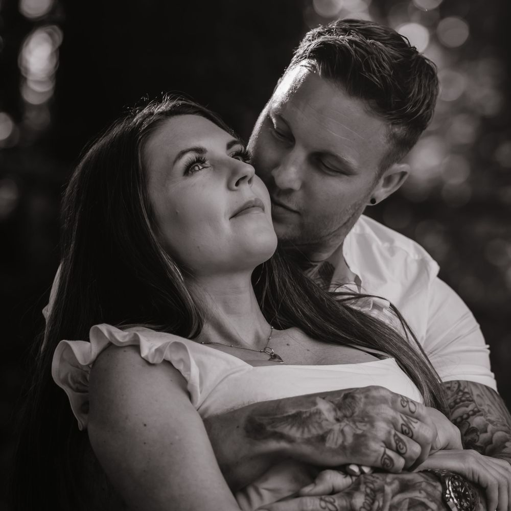 Intimate black and white portrait of couple sharing tender moment.