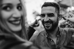 Couple framed by neon lights – Lisbon urban love session