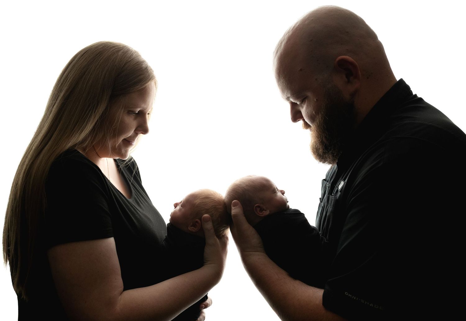 Mom and Dad are looking at the twins being backlit with the lighting. Greenville SC newborn photographer, Easley SC newborn photographer