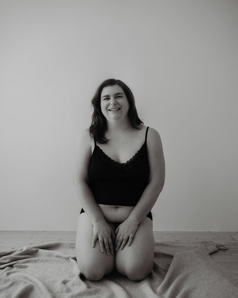 Natural black and white portrait showing genuine emotion on textile background.