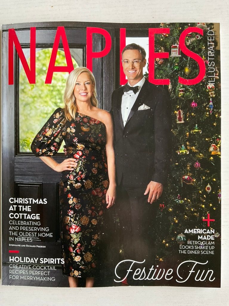 Naples Illustrated holiday issue cover featuring a couple in festive attire with Christmas decorations.