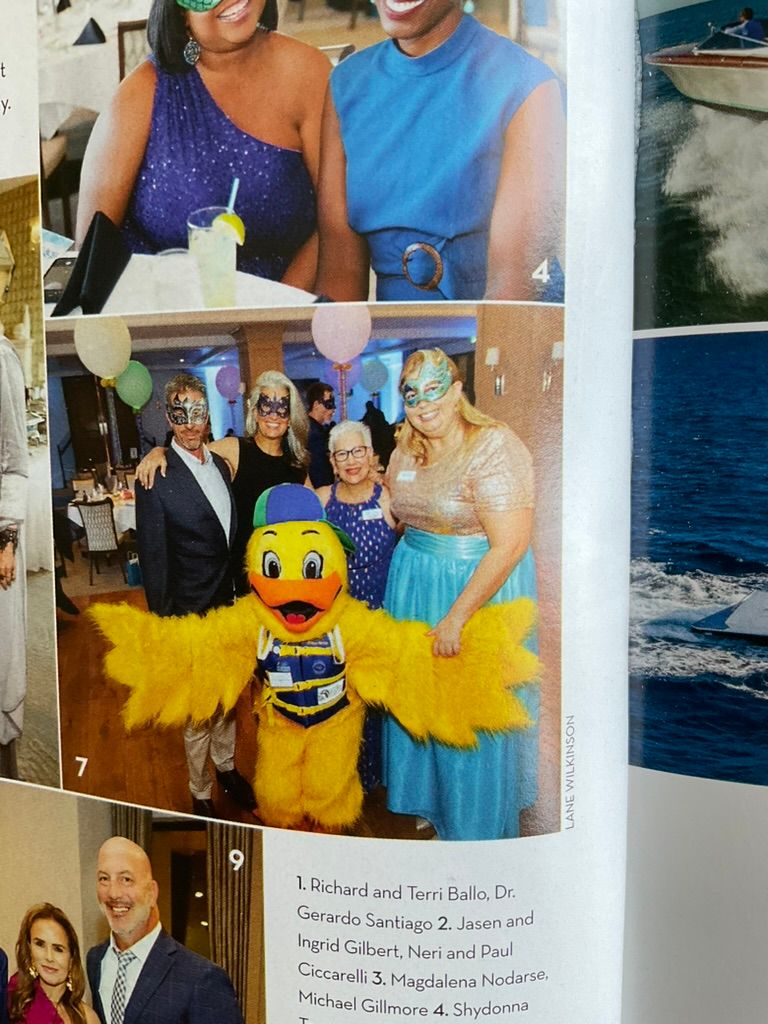 Naples Illustrated magazine page showing Aqua Ball guests including Richard and Terri Ballo with a yellow duck mascot costume.