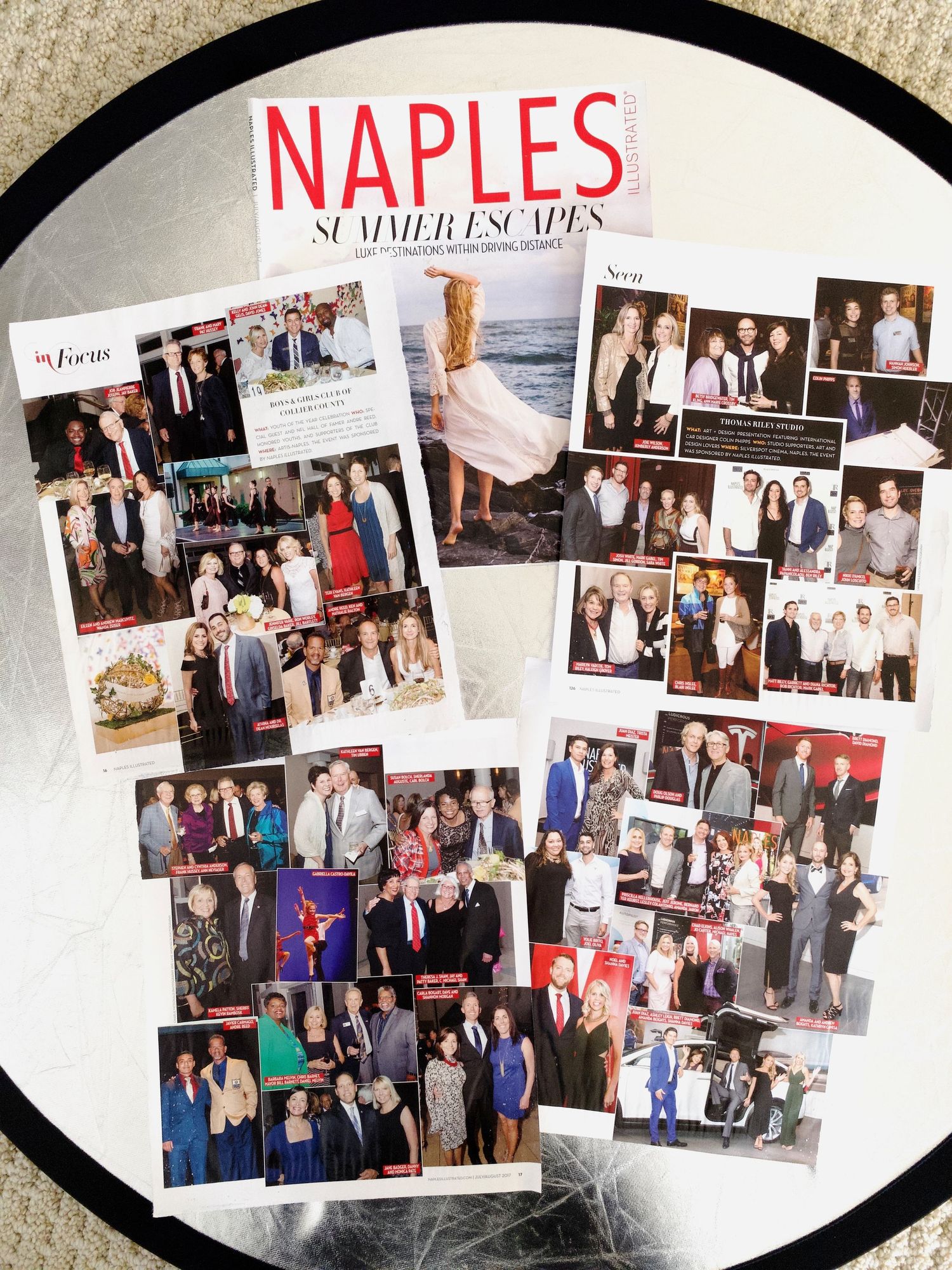 Naples Illustrated Summer Escapes issue displayed with multiple social event photo spreads fanned open.