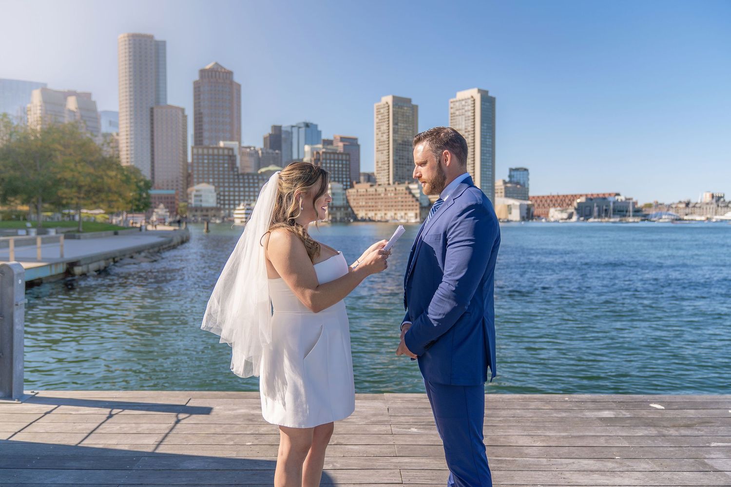 Couple exchanging private vows during their elopement in Boston Seaport District, Massachusetts.