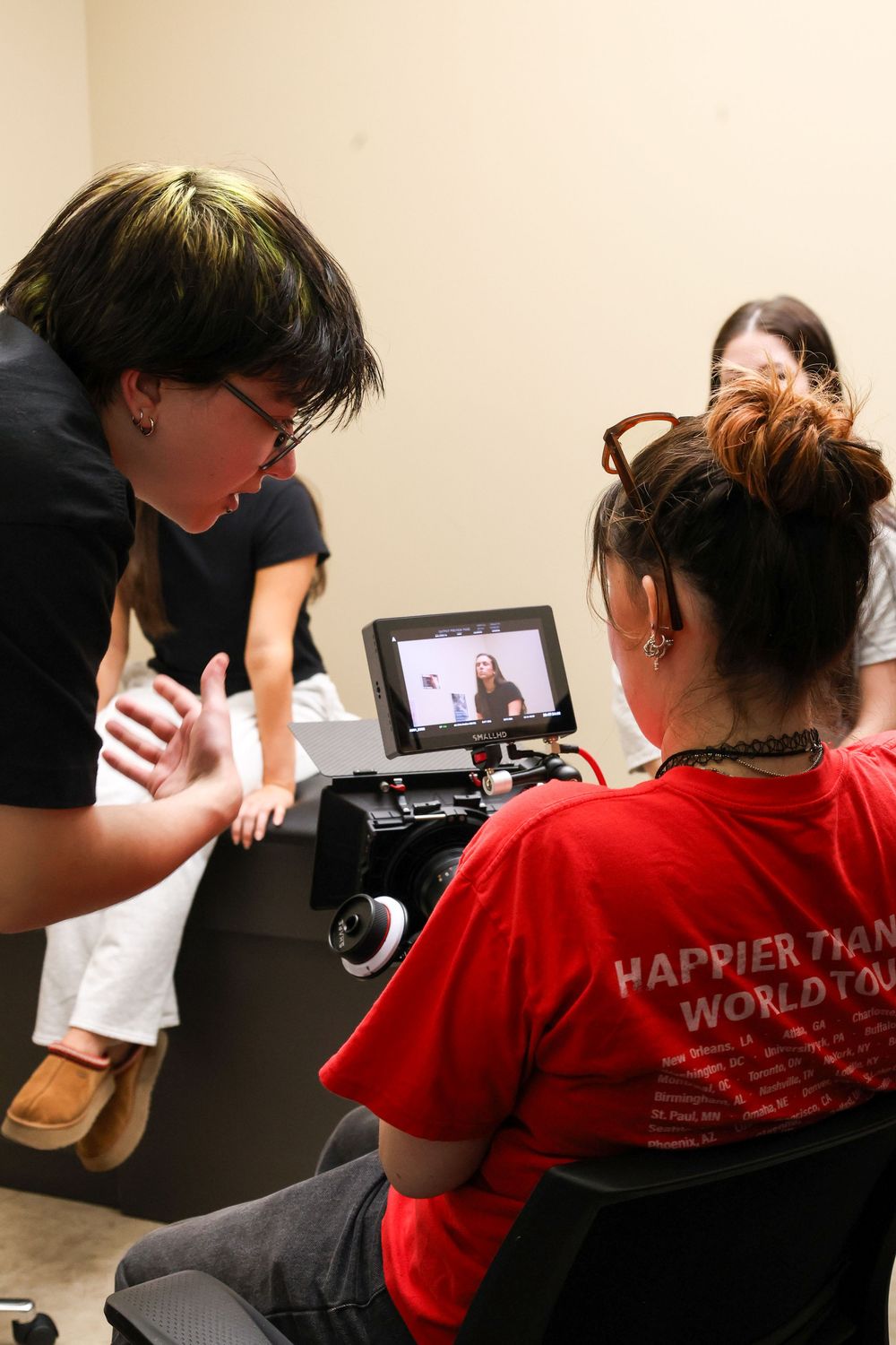 A sequence of photos shows someone in a red t-shirt using a tablet device while sitting at a desk.