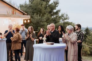 guests react to surprise wedding announcement at an intimate elopement outdoors in New Brunswick September micro-wedding photography Moncton