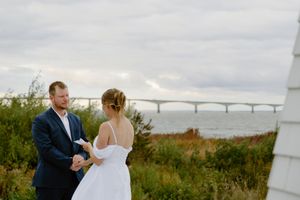 Couple exchange vows in romantic elopement at sunset at the Bridge to PEI, Cape Jourimain Nature centre wedding photography packages near me