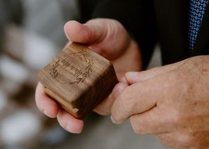 Father hands groom wedding rings in micro-wedding elopement photography in Newfoundland, St. John's wedding photographer packages near me