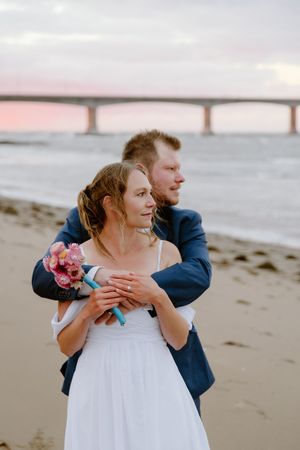 Couple embrace at sunset during October elopement on PEI, Maritime wedding photographer, Canadian destination wedding photography packages
