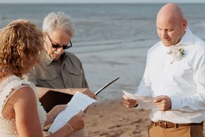 couple exchange vows in intimate elopement at sunset, Canadian elopement photographer in New Brunswick wedding packages at an hourly rate