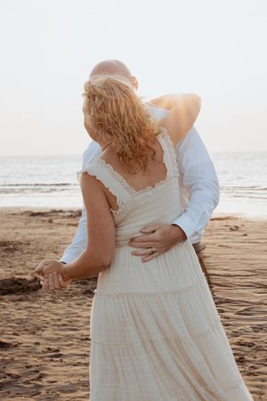 Couple dance at sunset on the beach Hopewell Rocks Alma Canadian travel wedding photography packages tourist photography in New Brunswick